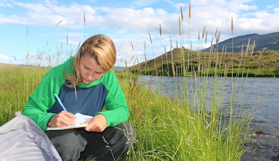 A student takes notes in the field in Iceland